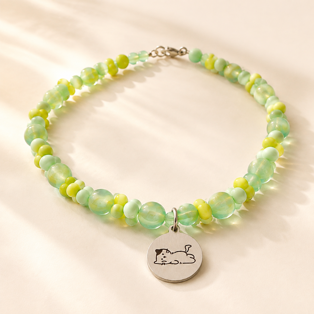 Personalized green beaded pet necklace with engraved ID tag